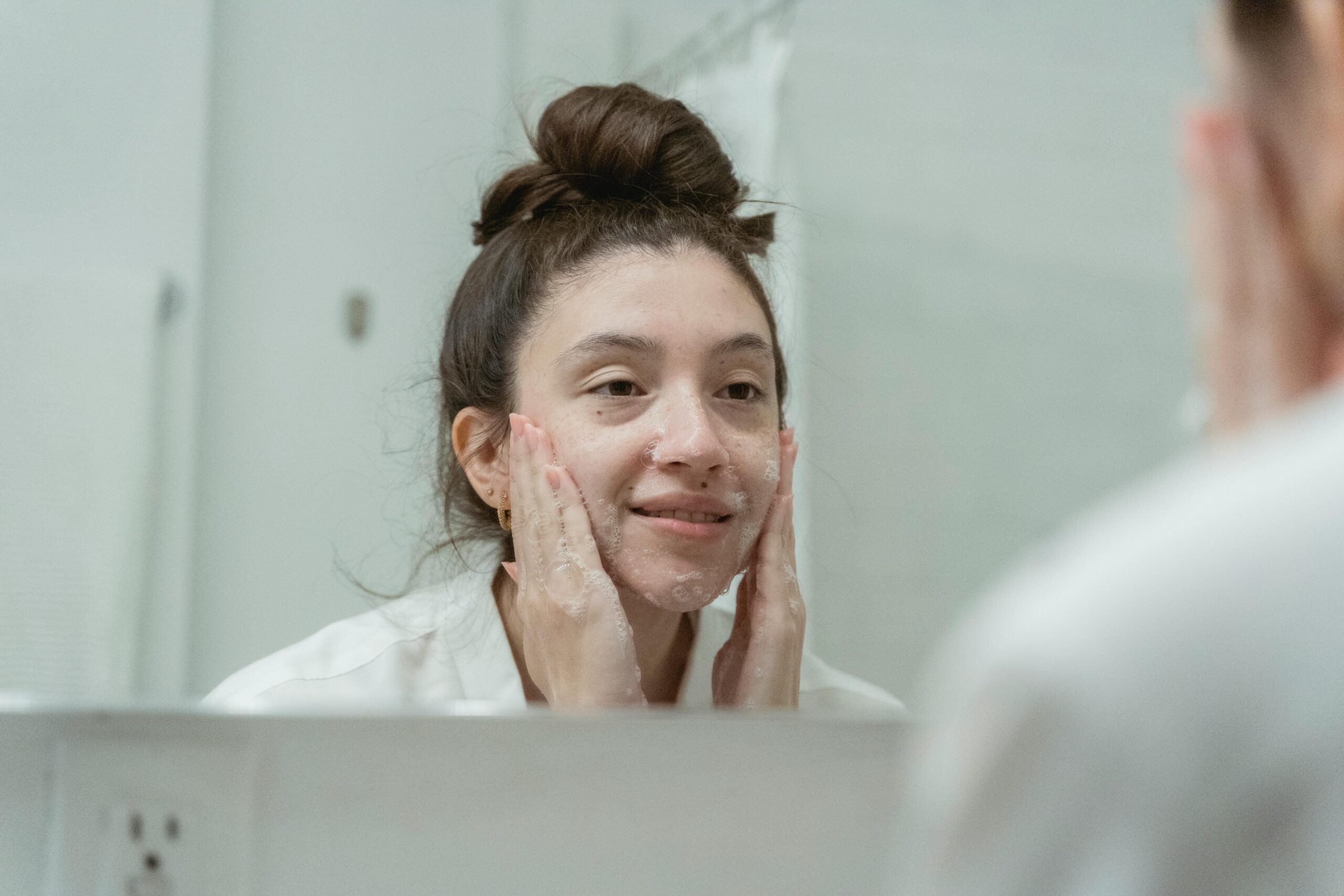 Girl doing skincare in mirror